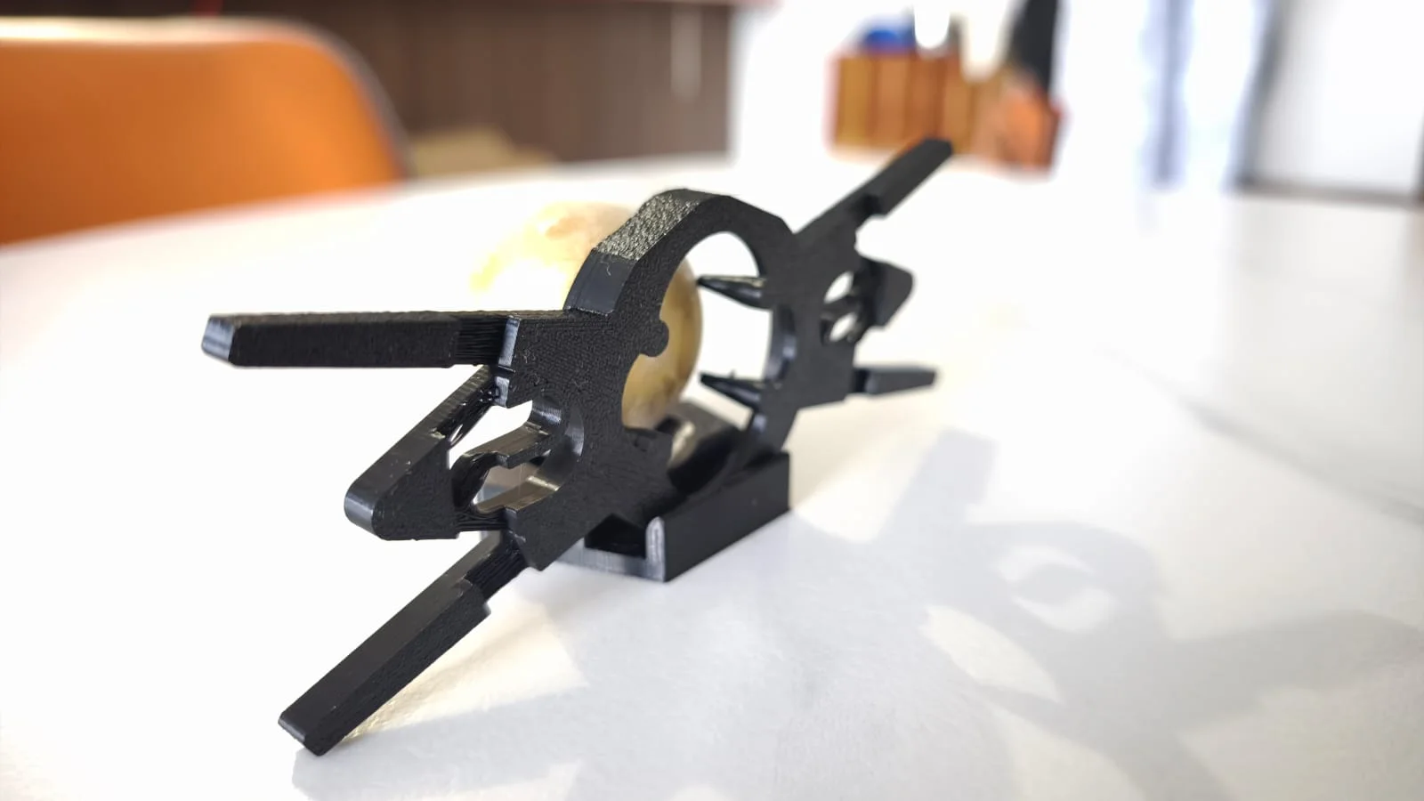 Three-quarter view of the 3D-printed El Injerto and Paragon interface holding the Chilling Rock.